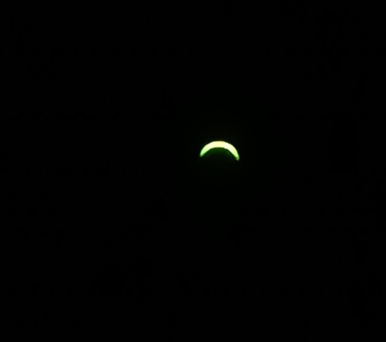 A view of the Partial Solar Eclipse on August 12, 2026, showing just a tiny sliver at the top of the sun.